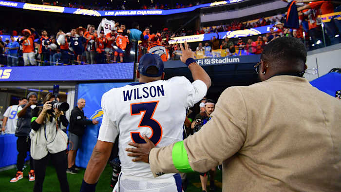 Russell Wilson waves to the crowd as he leaves the field